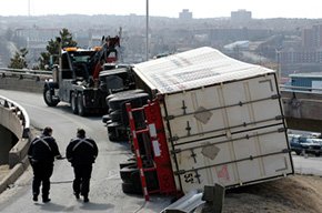 Tractor-trailer turned over on the road after an accident