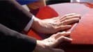 Two hands on casket