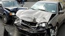 two wrecked vehicles with heavy front end damage