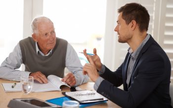 Attorney talking with older man