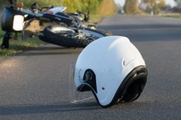 White helmet and motorcycle on road