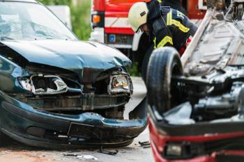 Emergency responder examining site of auto accident