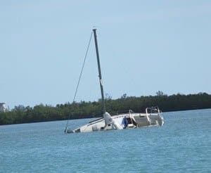 Capsized sailboat sinking.