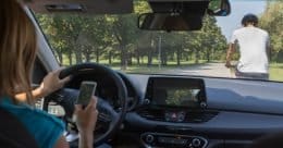 Rideshare driver texting and about to hit bicyclist in front of her