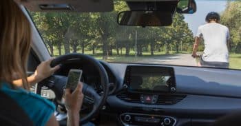 Rideshare driver texting and about to hit bicyclist in front of her