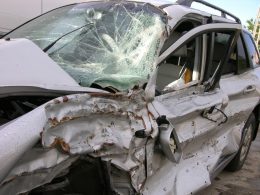 gray suv with shattered windshielf and battered drivers side following accident