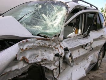 gray suv with shattered windshielf and battered drivers side following accident