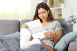 woman injured in car accident reading settlement offer from insurance
