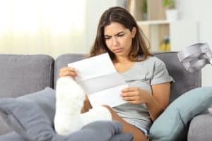 woman injured in car accident reading settlement offer from insurance