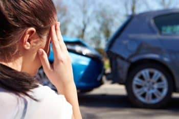 woman on phone after car accident