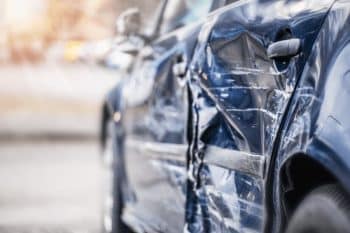 Close up of a car that’s been sideswiped in an accident