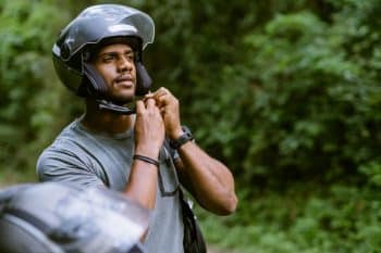 A motorcyclist fastening his helmet strap