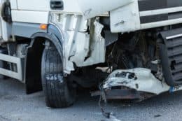 Close up of front-end damage to a white tractor trailer
