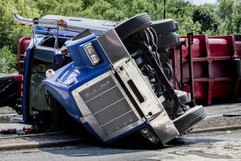 Blue semi-truck rolled over after an accident